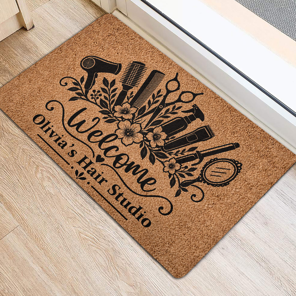 Hairdresser welcome doormat placed inside an entryway with black salon tool and floral artwork