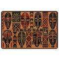 African-inspired doormat with stylized tribal masks, geometric motifs, and warm earth-tone colors
