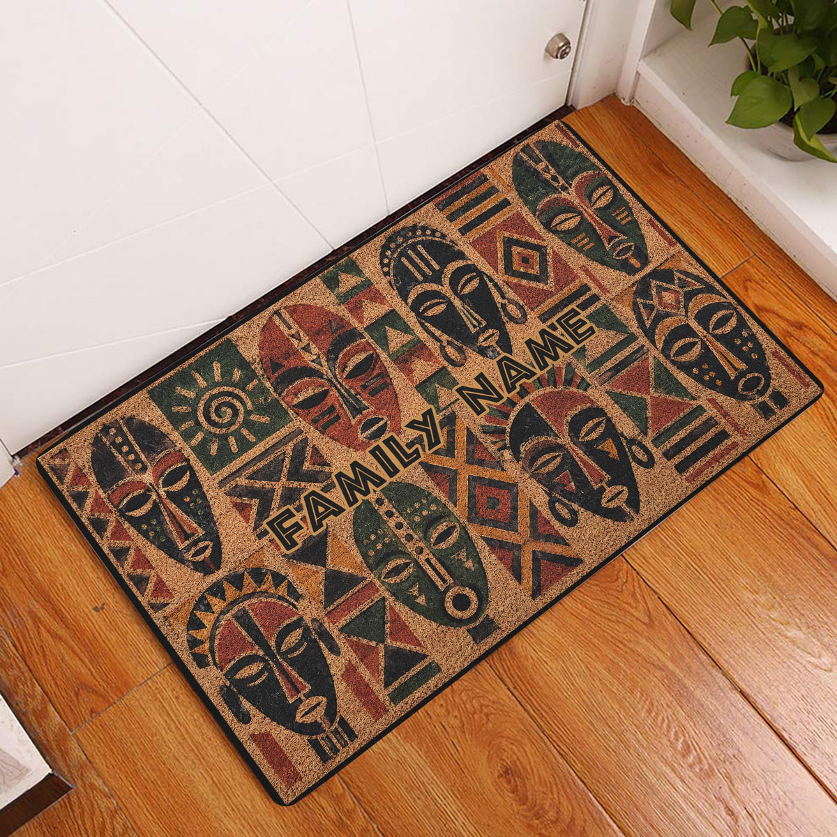 African mask pattern doormat displayed at a home entrance on a warm wood floor