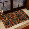 African art doormat arranged inside a home entrance with warm wood and glass doors