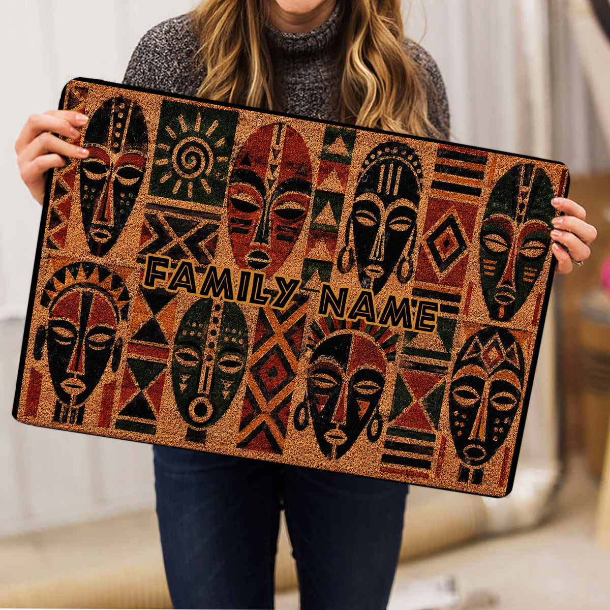African mask design doormat shown in a home setting with bold earthy colors and geometric details