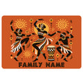 African-inspired doormat featuring three dancers, sun motifs, geometric patterns, and a hand drum on an orange background