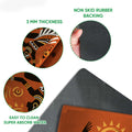 Close-up product detail showing the African dancer print, felt-like surface, rubber backing, and rounded doormat edge