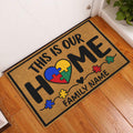 Colorful autism puzzle-piece heart doormat displayed in a welcoming indoor entryway
