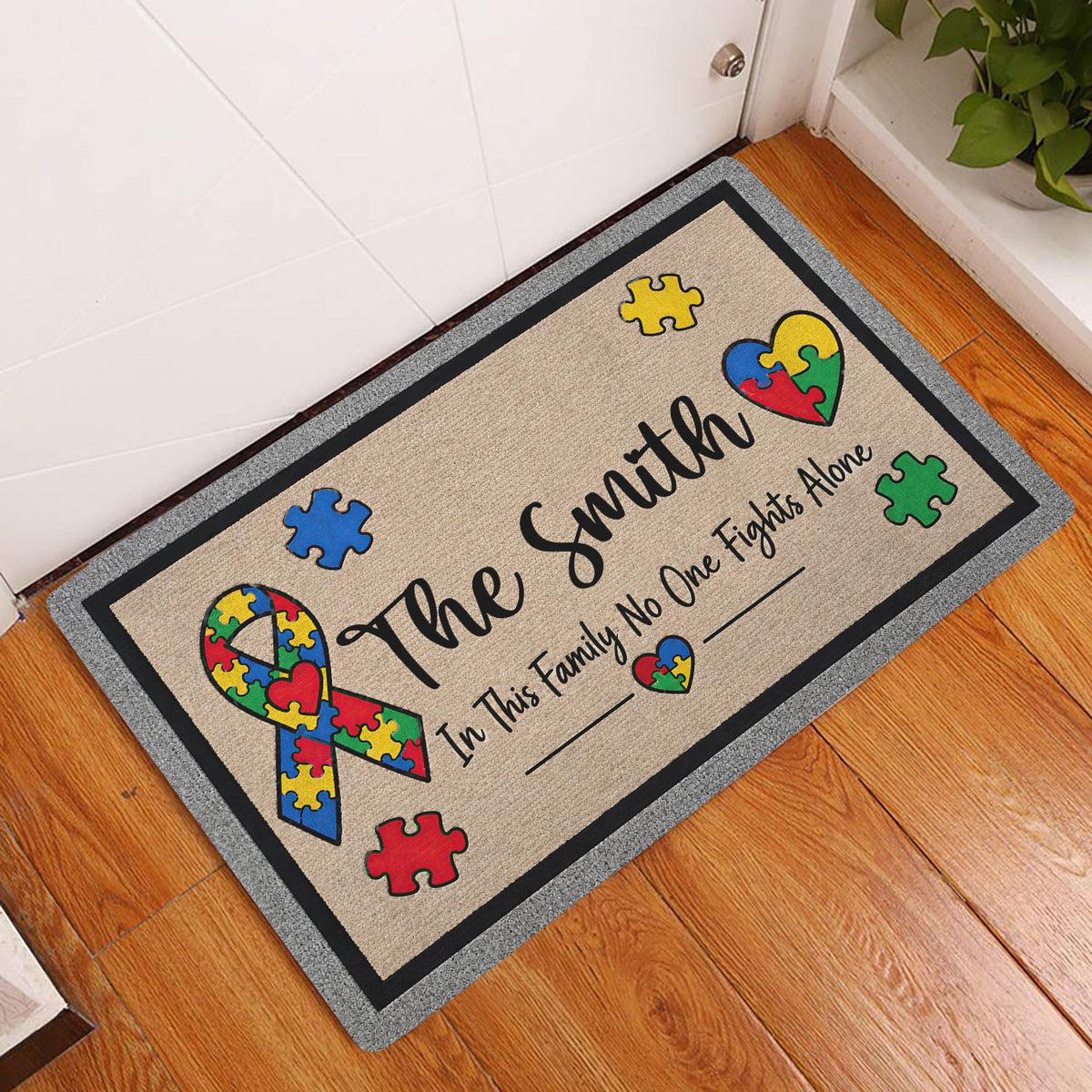Autism awareness entryway doormat displayed beside a white door on a wood floor
