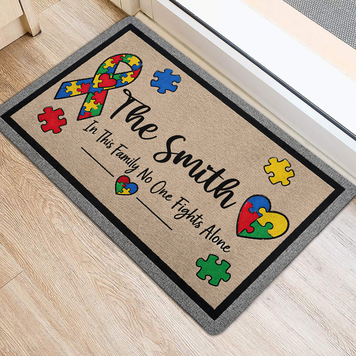 Colorful autism awareness ribbon doormat positioned near a doorway on a light wood floor