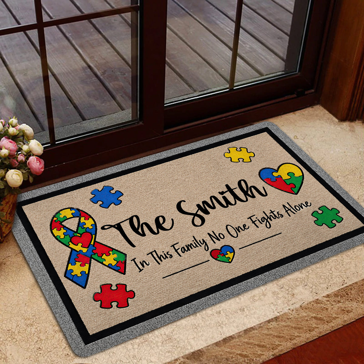 Autism awareness door mat styled in an indoor entrance beside a glass door
