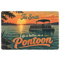 Pontoon doormat featuring a sunset lake scene, pontoon boat, evergreen trees, and decorative lettering