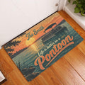 Pontoon doormat styled at an indoor doorway with a sunset lake scene and boat artwork on wood flooring