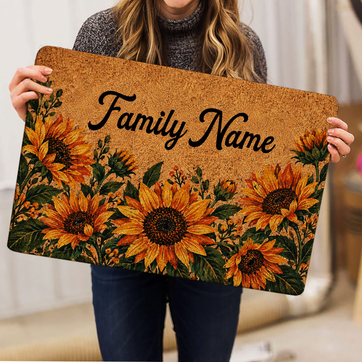 Sunflower doormat held indoors, showing golden floral artwork and dark green leaves