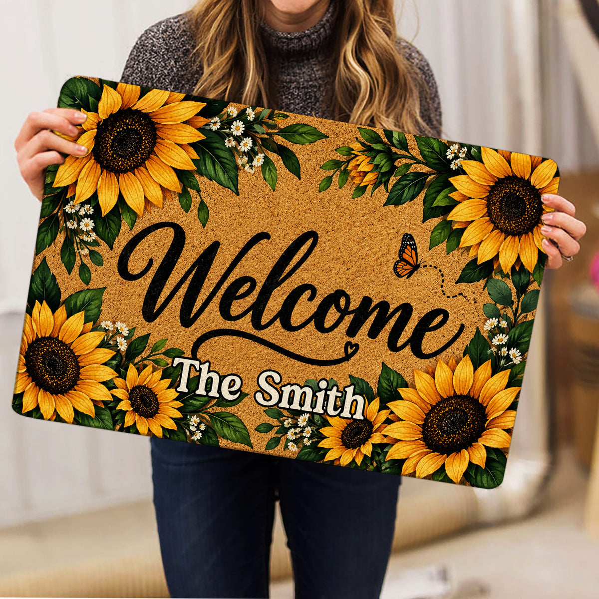 Sunflower doormat held indoors, showing the full golden floral border and welcoming design