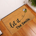 Bee welcome doormat displayed by a white door on a warm wood floor