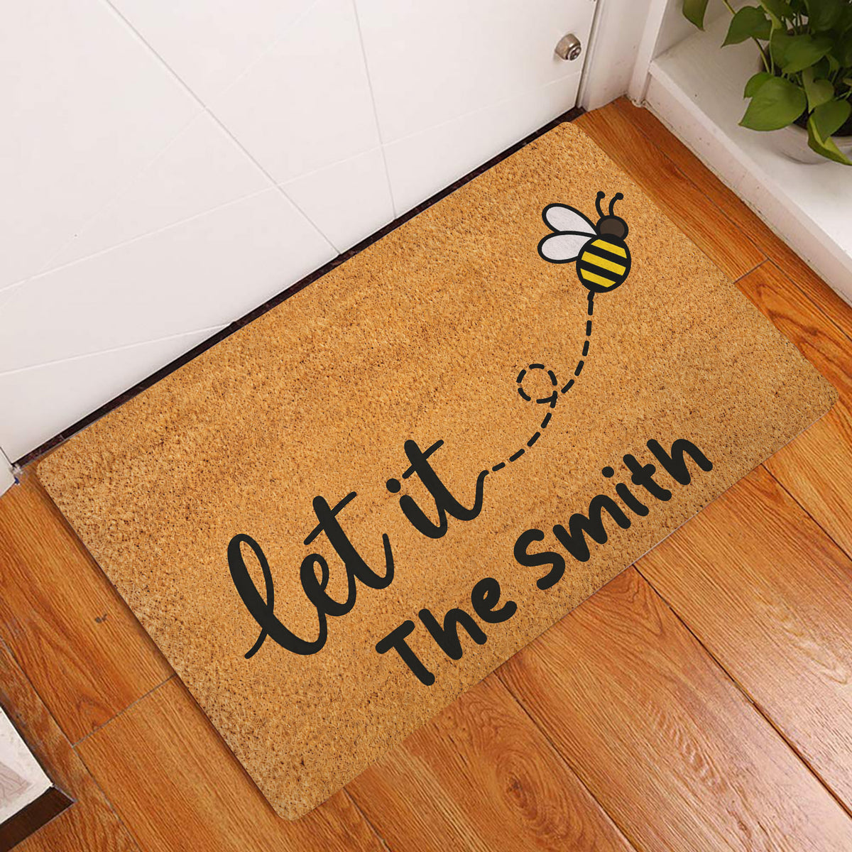 Bee welcome doormat displayed by a white door on a warm wood floor