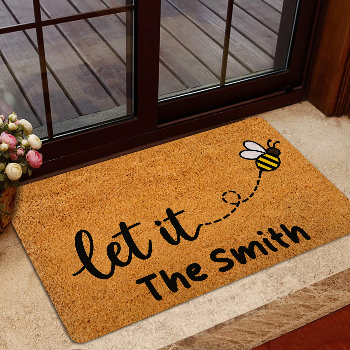 Bee-themed front door mat styled in a home entrance with a glass door