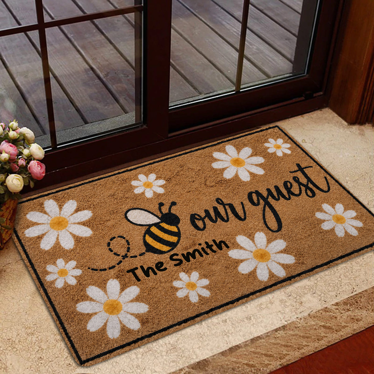 Bee and daisy entryway mat styled near a glass door with flowers and a welcoming design