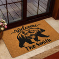 Bear silhouette entryway mat styled beside a glass door with a wood deck and home decor setting