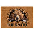 Bear doormat featuring a realistic brown bear breaking through a textured surface with bold lettering