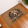 Bear entryway rug displayed in front of a door on a wood floor with a dramatic bear artwork design