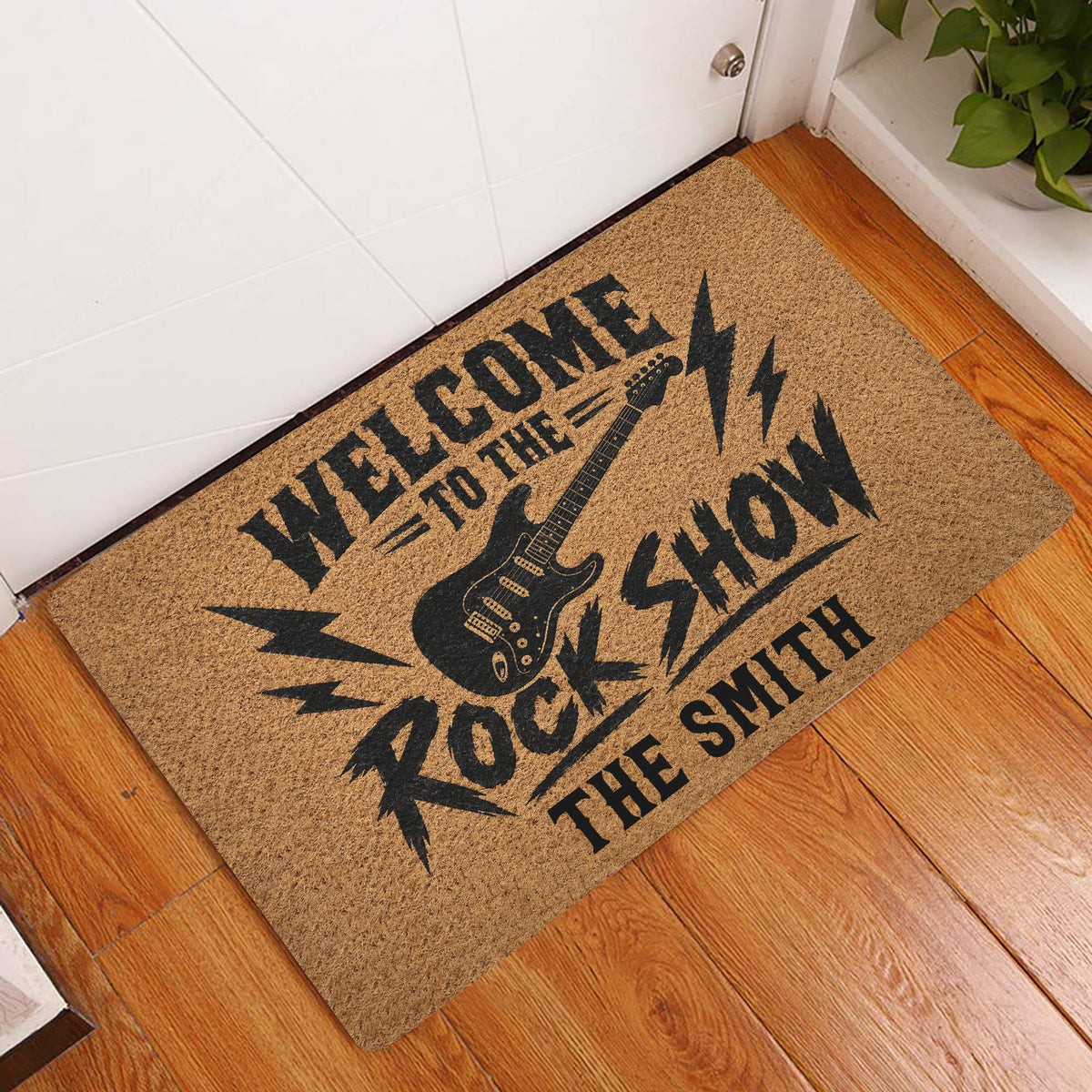 Rock and roll entryway rug displayed beside a white door on a hardwood floor