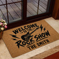Rock and roll welcome mat displayed near a glass door with guitar and lightning artwork