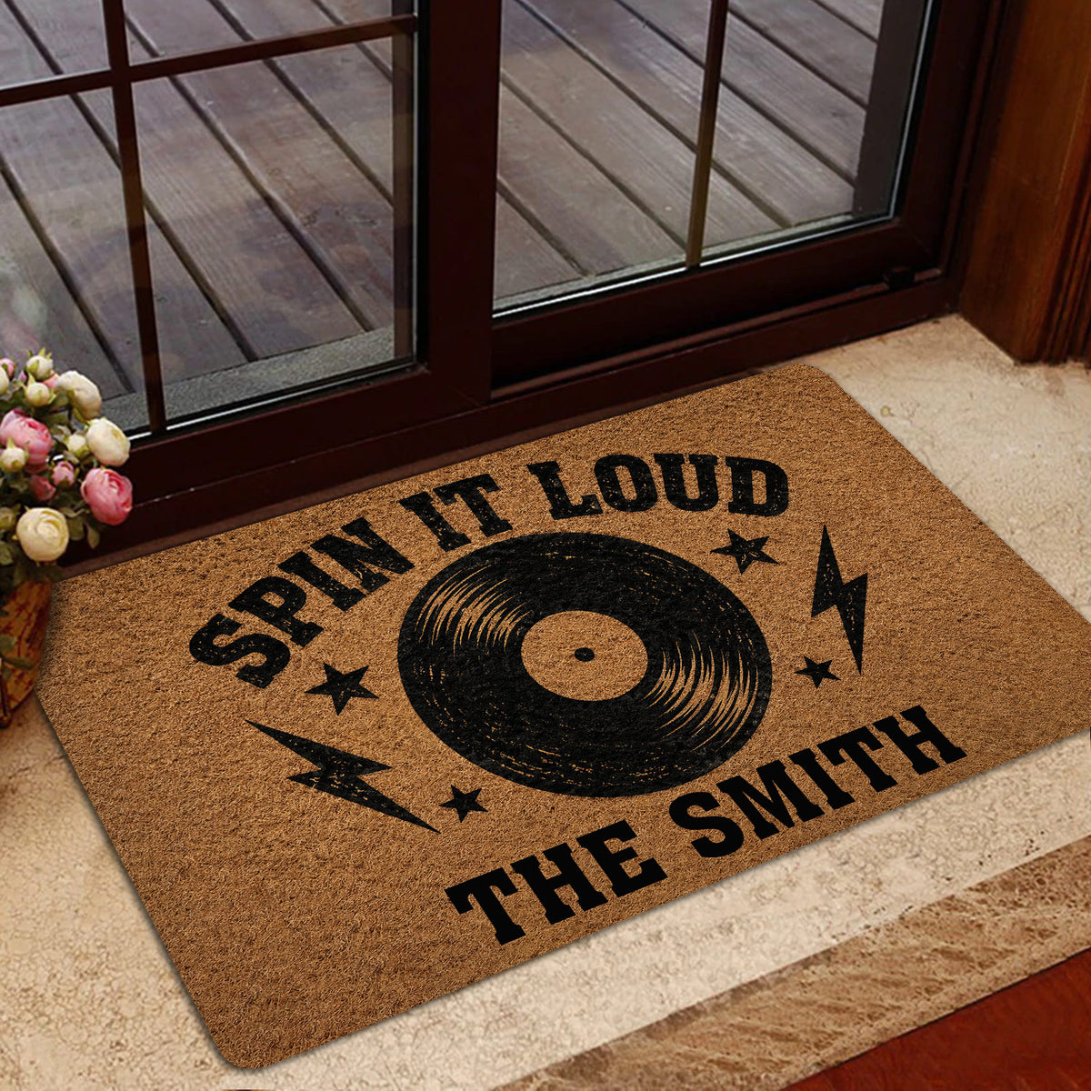 Rock and roll doormat styled inside a home entrance near glass doors and a floor rug