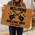 Rock and roll doormat held indoors, showing crossed electric guitars and distressed typography