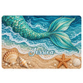 Mermaid doormat featuring a turquoise tail, ocean waves, seashells, and starfish on a sandy beach design