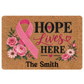 Breast cancer awareness doormat with pink ribbon, flowers, and Hope Lives Here artwork