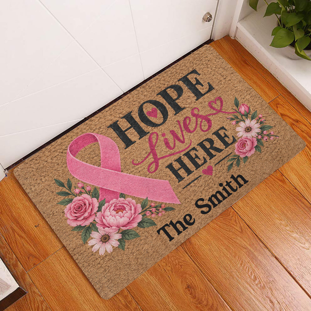 Breast cancer awareness entryway doormat with pink ribbon and floral Hope Lives Here design