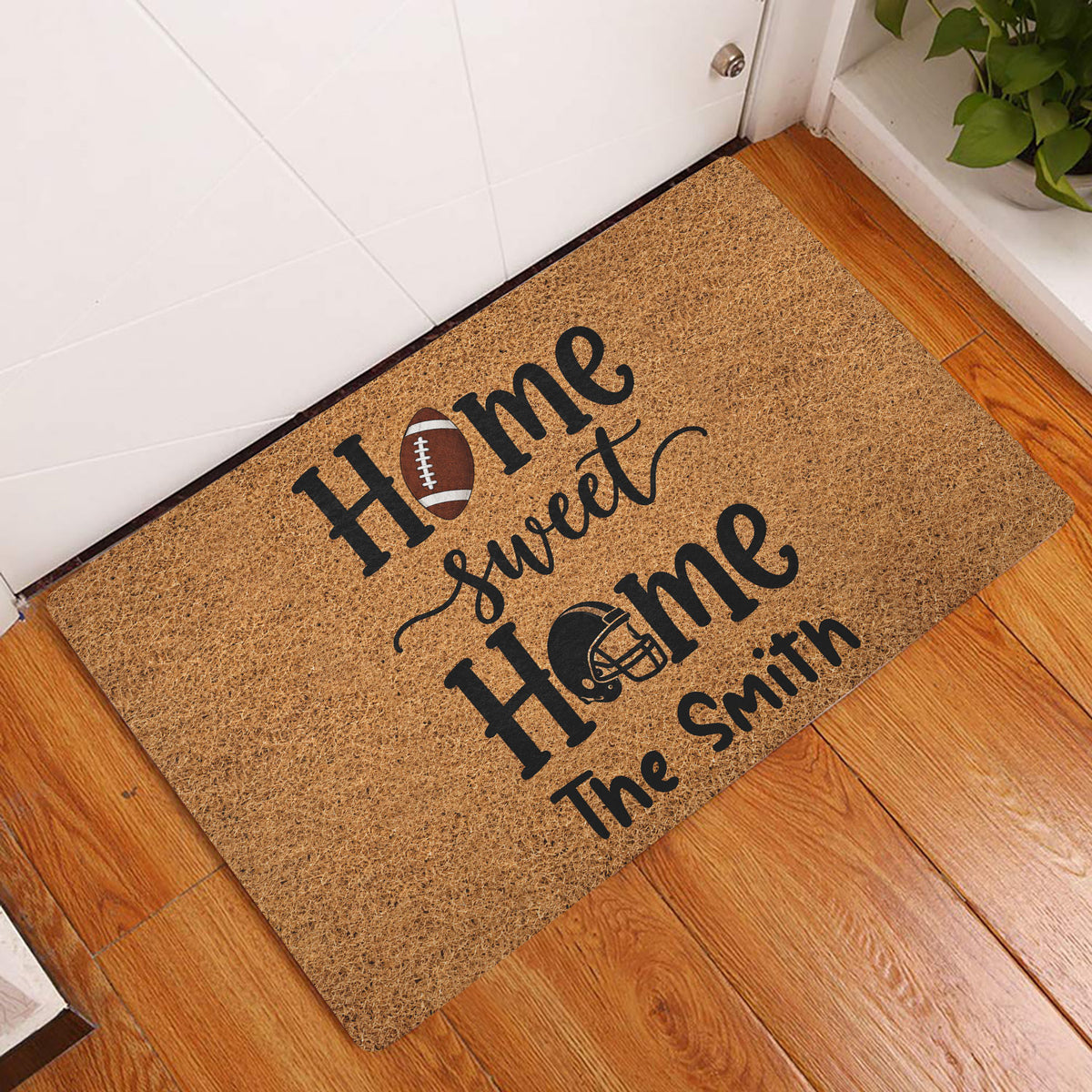 Football home doormat displayed at an indoor entryway on warm wood flooring