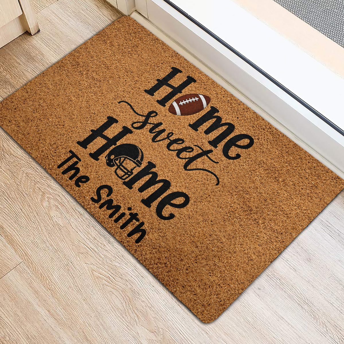Football-themed entryway rug positioned beside a doorway on light wood flooring
