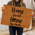 Football-themed doormat held indoors, showing bold lettering with football and helmet artwork