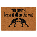 Wrestling doormat with two grapplers on a textured brown background and bold black lettering