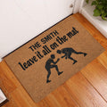 Wrestling doormat displayed at an indoor doorway on warm hardwood flooring