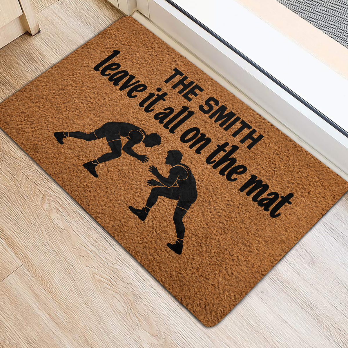 Wrestling entryway mat featuring two grapplers and bold black lettering near a door