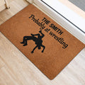Wrestling silhouette doormat displayed near a doorway on light wood flooring