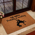 Wrestling-themed door mat shown in a home entrance beside glass doors and an indoor rug