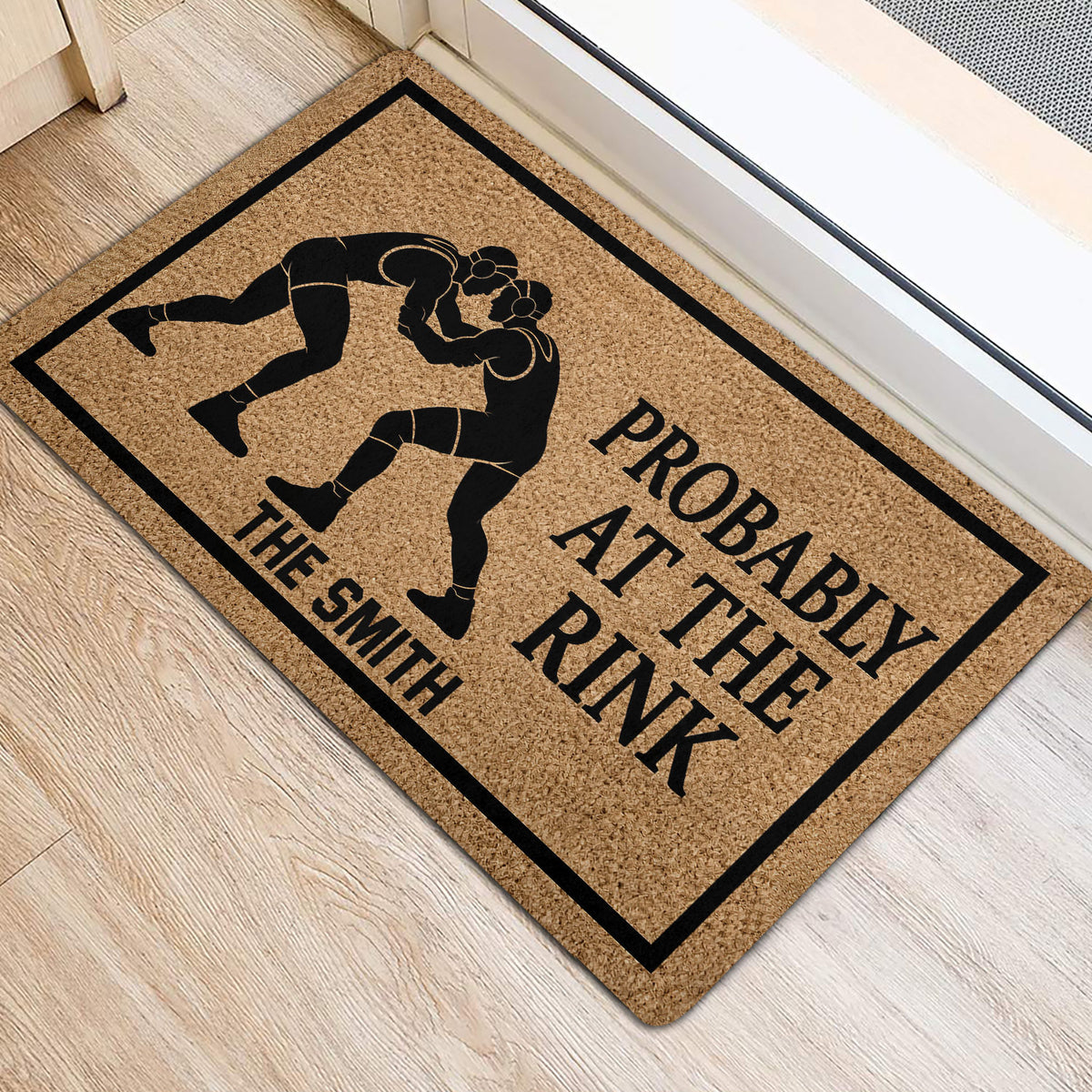 Wrestling entryway mat displayed beside a doorway with two grapplers and bold black graphic details