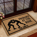 Wrestling door mat shown in a home entrance with grappler silhouettes, black border, and bold lettering