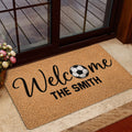 Soccer welcome rug styled in a home entrance beside a glass door
