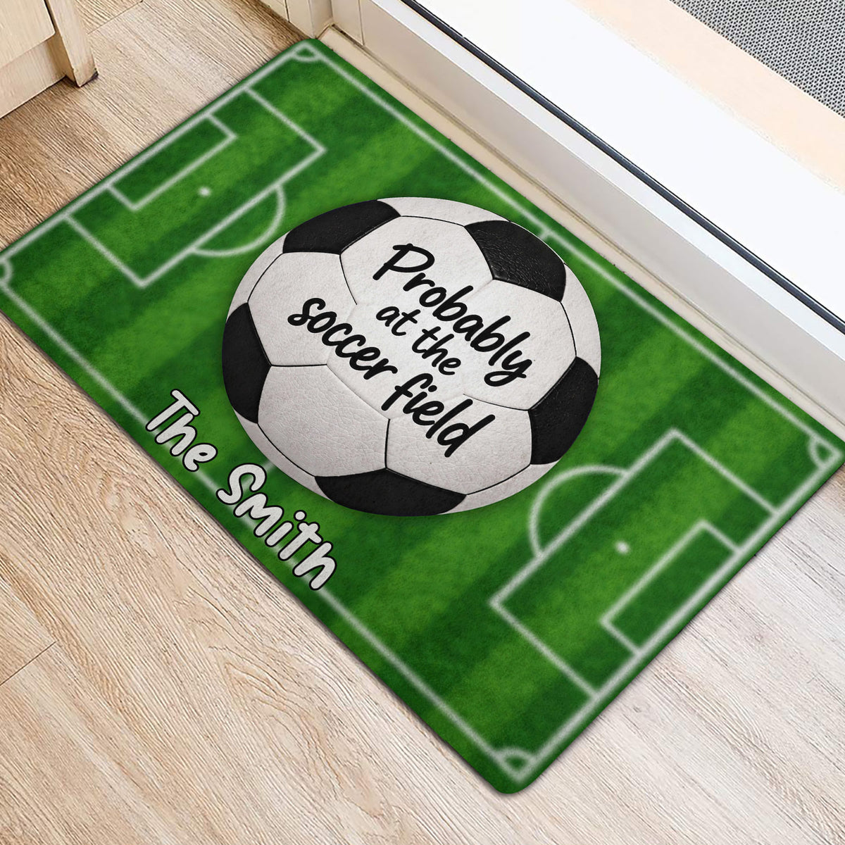 Green soccer field entryway rug with a soccer ball graphic and playful lettering