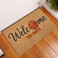 Basketball welcome doormat displayed inside a home entryway on a warm wood floor