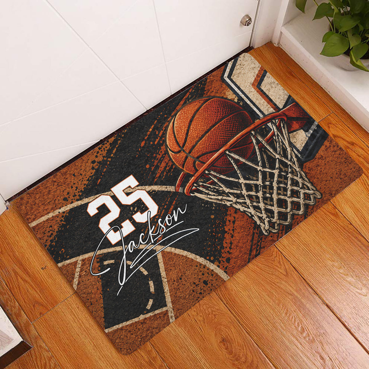 Basketball entryway doormat displayed on a wood floor beside a white door