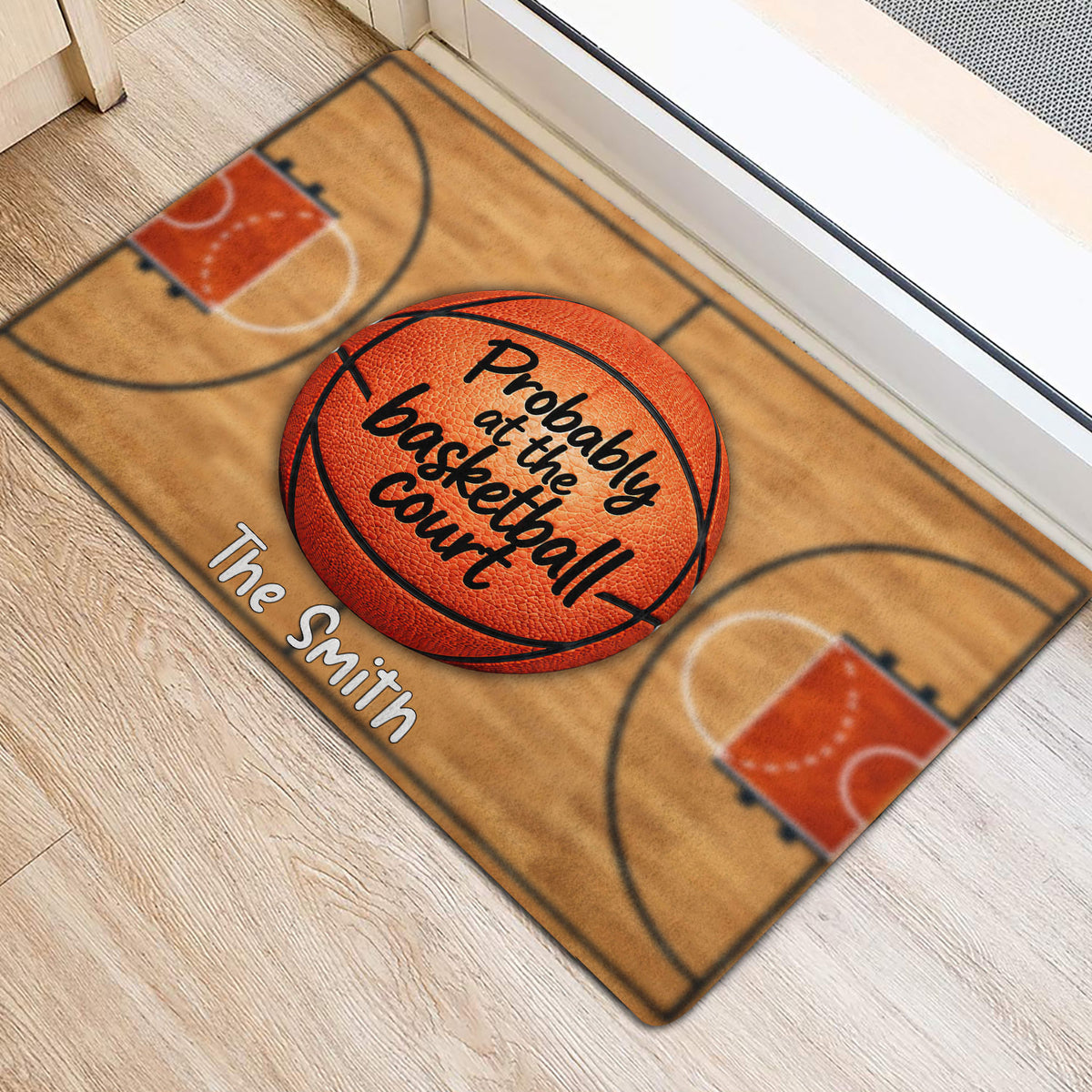Basketball-themed entryway mat shown beside a doorway with court lines and orange hoops