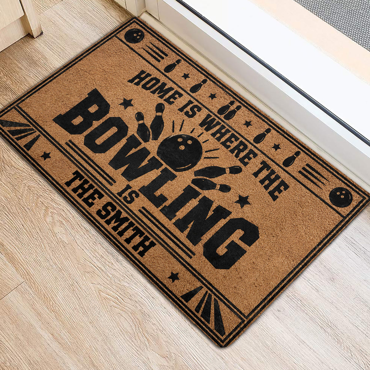 Bowling-themed entryway rug placed beside a doorway with bold black and tan graphics