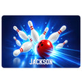 Bowling doormat design with a red ball striking white pins against a vivid blue background
