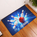 Bowling doormat displayed by an indoor doorway on a wood floor with blue, red, and white artwork