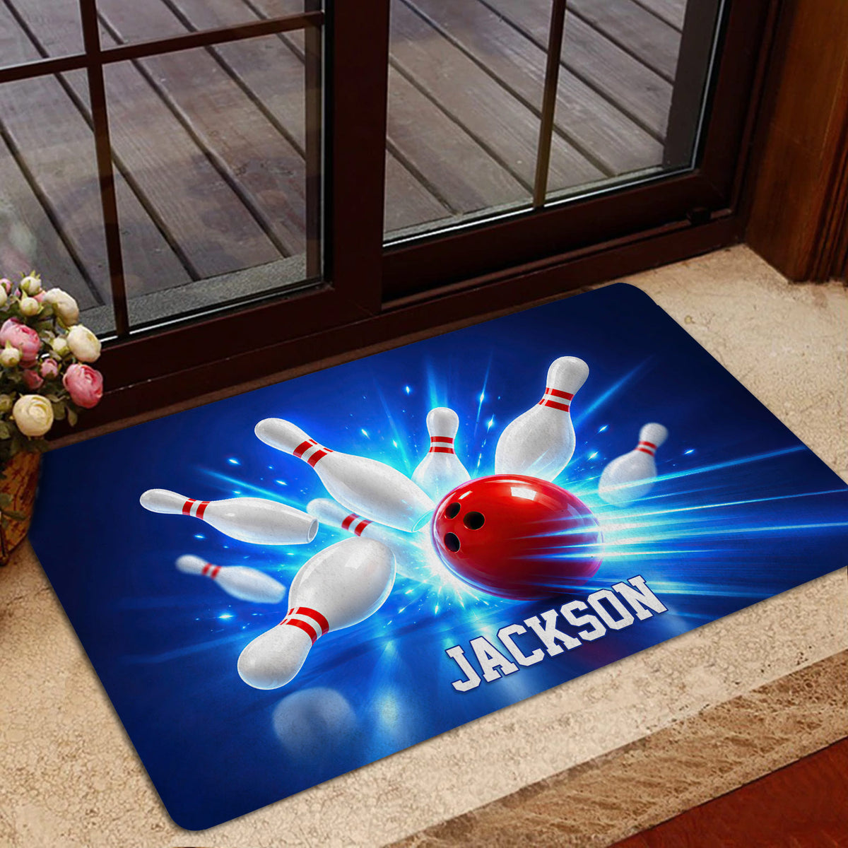 Bowling-themed entryway mat shown near a glass door with vivid blue artwork and red bowling ball