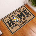 Volleyball doormat displayed at an indoor entryway beside a white door and wood floor