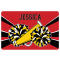 Cheerleading doormat featuring colorful pom-poms and a megaphone in bold red, black, white, and yellow